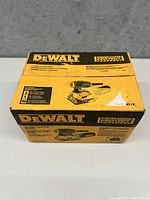 Photo of the Dewalt sander box showing front and top with product details and branding
