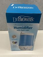Photo of the closed original box showing the branded humidifier with product description and image.