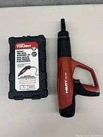 Hilti DX460 portable gas nail tool next to Hyper Tough rotary tool case.