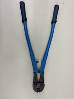Top-down view of the JET bolt cutters with blue handles and black gripping ends, showing full length and cutting head.