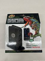 Front of box showing the Zoo Med Environmental Control Center device and its digital display with frog images on packaging.
