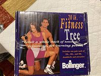 Box with product name '20 lb Fitness Tree' by Bollinger featuring image of man and woman using dumbbells.