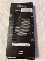 Top view of the Crestron DM-RMC-4K-Scaler-C4K showing brand, model details, control ports and power specifications.