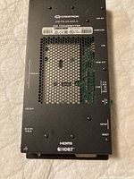 Top view of Crestron DM-TX-4K-202-C DM transmitter with ventilation holes and port labels visible.