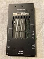 Top view of the Crestron DM-TX-4K-202-C transmitter showing ports and ventilation mesh panel