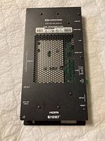 Top view showing model number, branding, various ports, and ventilation openings on transmitter unit.