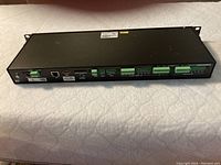 Rear and side view of black rack mountable Crestron CP3N 3-Series control processor showing all connection ports and Ethernet port.