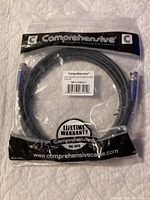 Packaged Comprehensive branded cable, sealed in plastic with visible lifetime warranty and logo.