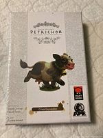 Front box cover showing Petrichor Cows Expansion with cartoon cow illustration and branding.