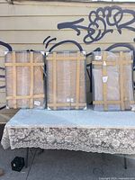 Three large rectangular picture frames still sealed in protective packaging, secured and taped for shipping and storage.