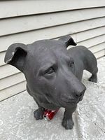 Front-side view of black bulldog statue showing facial details and stance