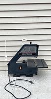 Front and left side view of the Craftsman bandsaw showing the control switch and worktable, approximately 27 inches wide and 24 inches tall.