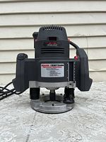 Front view showing label, cord, and base plate of the Craftsman Professional Router.