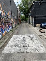 Full view of rectangular area rug laid flat showing faded distressed pattern