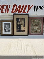 Three framed vintage royal pictures displayed side by side outdoors
