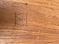 Close-up photo of the branding on the teak base showing Digsmed Denmark mark.