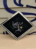 Front of the diamond-shaped framed airbrush artwork showing the dancer on black field with mirrored frame border
