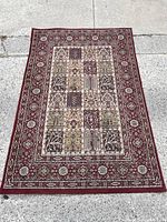 Full view of the Turkish style area rug laid flat on concrete showing pattern and condition