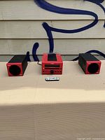 Yamaha CRX-40 bookshelf stereo system including main control unit, two speakers, and remote control displayed on a beige surface in front of a beige wall with blue graffiti.