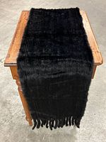 Full length view of black mink scarf draped over small table top