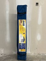 Blue carrying bag with label displaying Broadstone Gallaghan portable gazebo features and measurements.