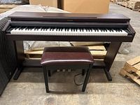 Full front view of Roland digital piano on stand with bench