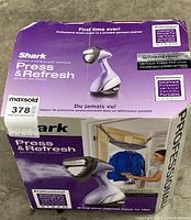 Box and packaging showing Shark Press & Refresh garment care system with images and features listed on box.
