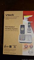 Photo of the product box showing VTech branding and product name 'Two Handset Cordless System with Caller ID/Call Waiting'