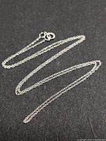 Full view of the 16-inch 10K gold twisted rope chain necklace laid flat against a black background.