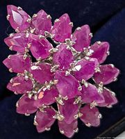 Top-down view of ring face showing pear-cut ruby cluster