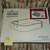 Box of All-Clad Stainless Steel Roti Pan showing brand and model details on packaging.