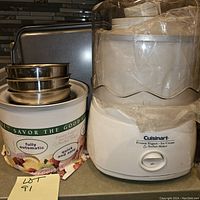 Cuisinart frozen yogurt, ice cream, and sorbet maker with its original box and packaging, and stainless steel bowls stacked inside the box.
