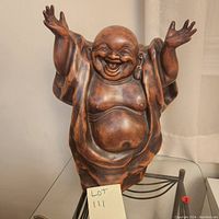 Front view of the resin Happy Buddha statue showing smiling face with open mouth and raised arms, draped in flowing robe.
