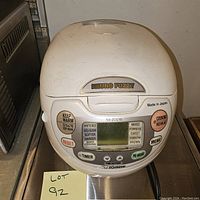 Front view of Zojirushi Neuro Fuzzy rice cooker showing control panel and buttons, powered off.