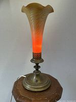 Full view of lamp unlit showing glass shade and brass base