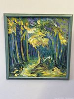 Full front view of square framed painting depicting forest path with thick impasto brushstrokes