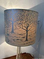Front view of lamp showing tree pattern shade and crystal glass base