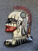 Full profile view of carved and painted wood bust