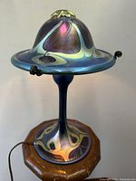 Front view of lamp showing iridescent shade and matching base