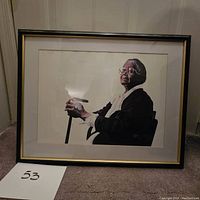 Frontal view of framed artwork showing elderly person holding cane, depicting detailed portrait art in black framed glass frame.