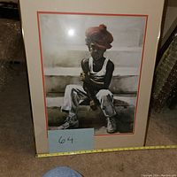 Photo showing full view of the framed artwork titled 'Destined for Greatness' by Holston with measuring tape indicating approximate size.