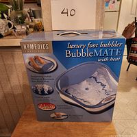 HoMedics BubbleMate luxury foot bubbler box showing front with product image and features.