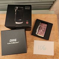 Photo of DXG HD camcorder box, branded Luxe Collection, showing camcorder packaging and box.