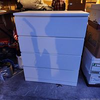 Front view of the white Ikea dresser showing four drawers with sleek minimalist design.
