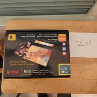 Image of Kodak P811 photo scanner box showing product branding, features, and included memory specifications.