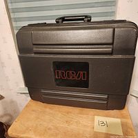 Closed black hard case with RCA logo in red letters on the front face