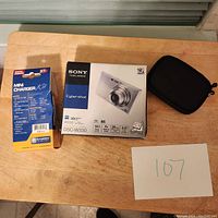 Full lot showing boxed Sony Cyber-shot DSC-W330 camera, black carrying case, and mini charger kit