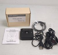 Photo of the adapter device with accompanying cables and user manual, alongside the plain cardboard packaging box labeled with model info.