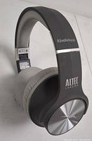 Gray Altec Lansing R3volutionX Bluetooth headphones showing side view with metallic outer ear cup detail.
