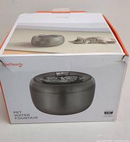 Box photo shows Pet Water Fountain packaging with image of the fountain and cat lounging nearby, labeled 2.5L capacity, brand FeelNeedy.